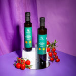 Aroma Olymp Bio Olivenöl nativ extra aus Kreta g. U. 250 ml – zwei Flaschen mit Tomaten auf lila Hintergrund arrangiert