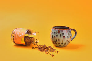 
                  
                    Aroma Olymp Bio Johanniskraut Tee im Mehrwegpfandglas. Daneben eine Tasse mit Tee.
                  
                